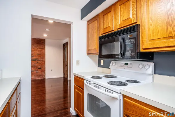 a kitchen with stainless steel appliances granite countertop a sink and a wooden cabinets