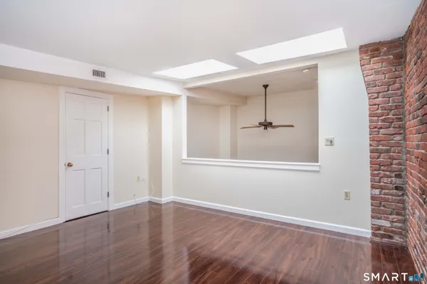 a view of a room with wooden floor