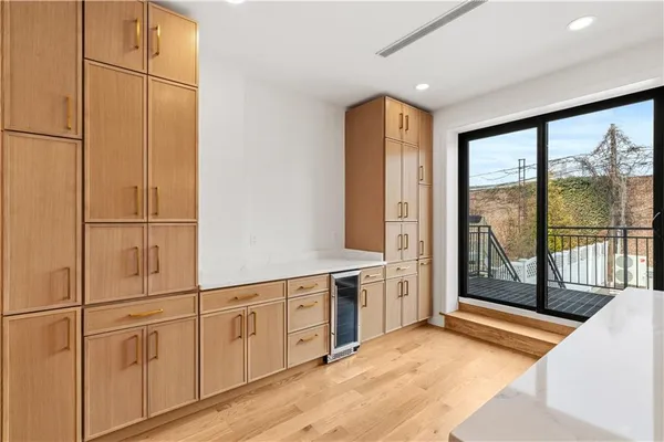 a view of a kitchen with wooden floor and iron cabinets