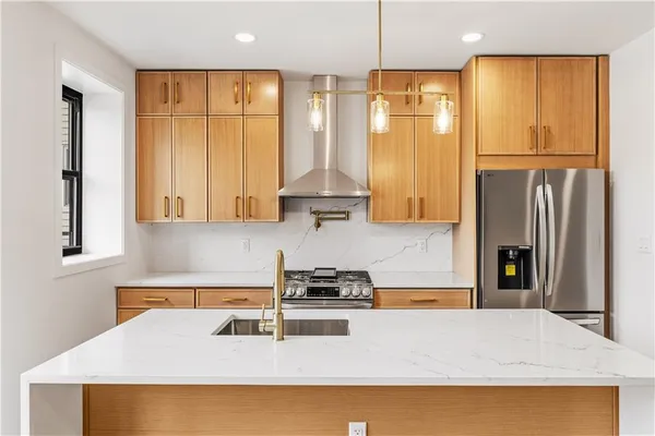 a kitchen with a refrigerator a sink and cabinets