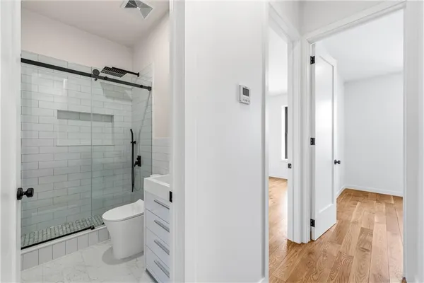 a bathroom with a shower toilet and sink