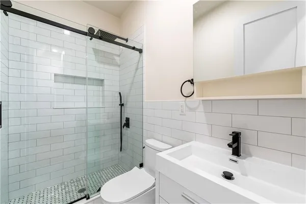 a bathroom with a sink toilet and shower