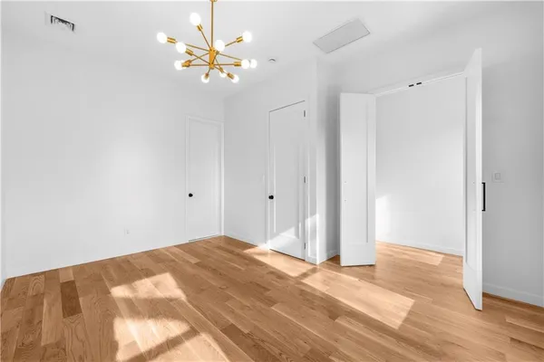 a view of a room with a ceiling fan and a window