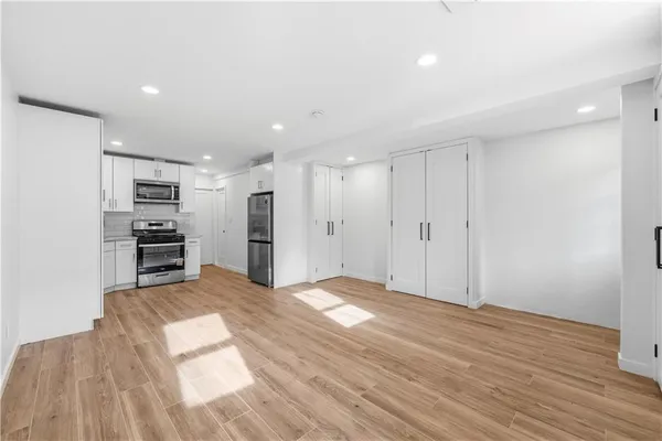 a view of a kitchen with wooden floor