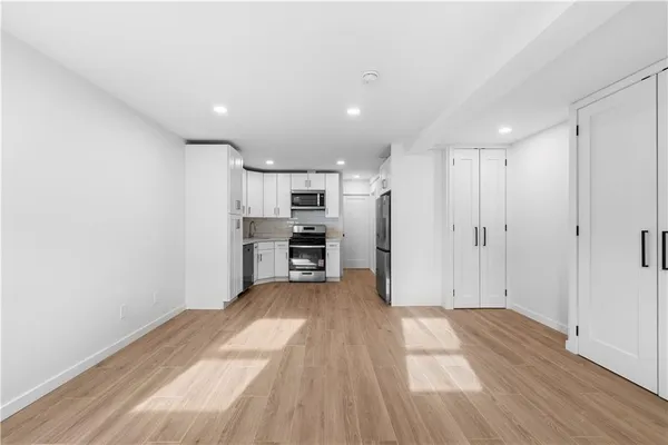 a view of kitchen with refrigerator microwave and stove