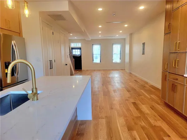 a view of a kitchen with a sink and cabinets