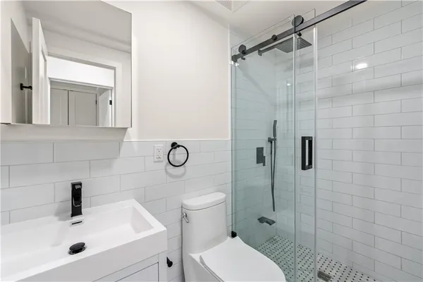 a bathroom with a sink toilet and shower