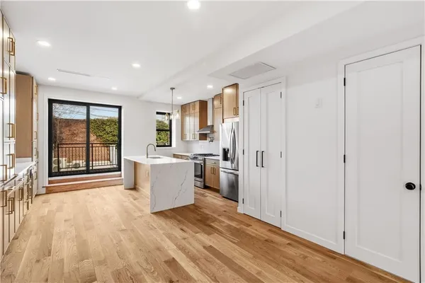 a view of a kitchen with furniture and wooden floor