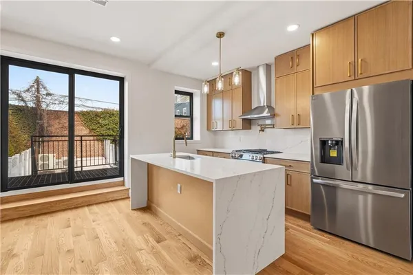 a kitchen with stainless steel appliances a refrigerator sink and cabinets