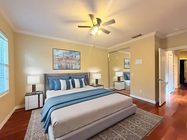 a bedroom with a large bed and a chandelier