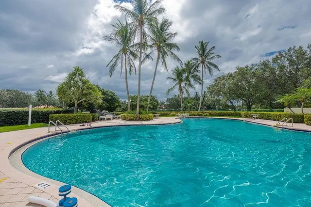 a view of a swimming pool with a yard