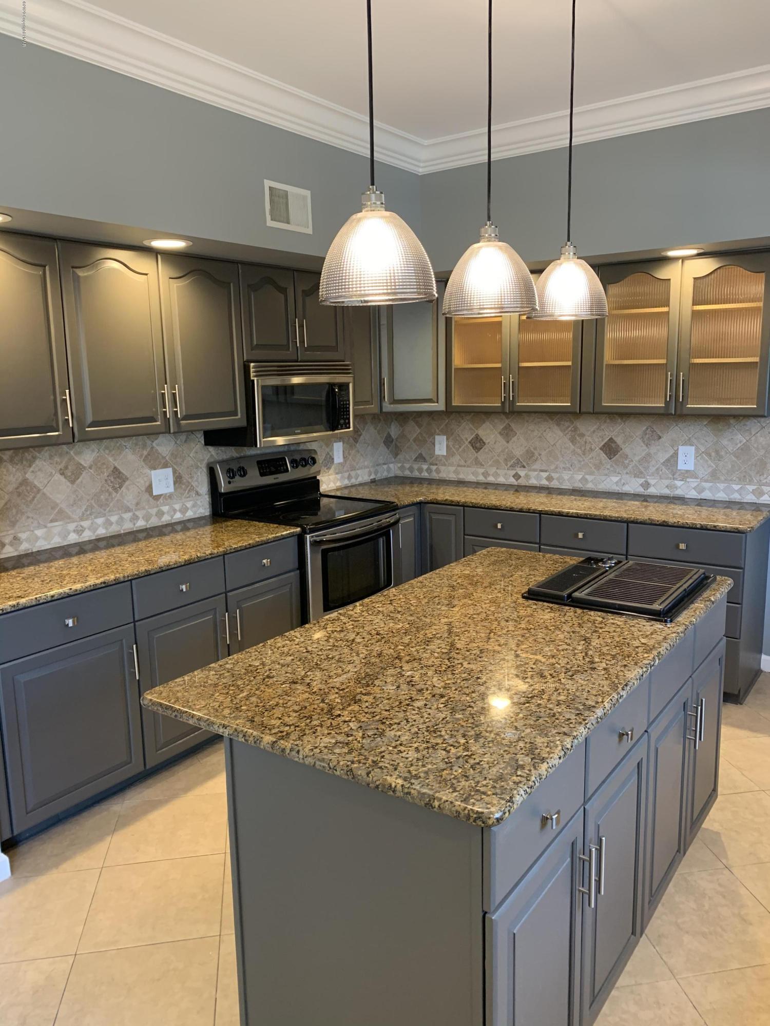 1697 Middle Road Stroudsburg, PA 18360 - Photo 53 of 116 a kitchen with stainless steel appliances granite countertop wooden cabinets a stove a sink a dining table and chairs with wooden floor