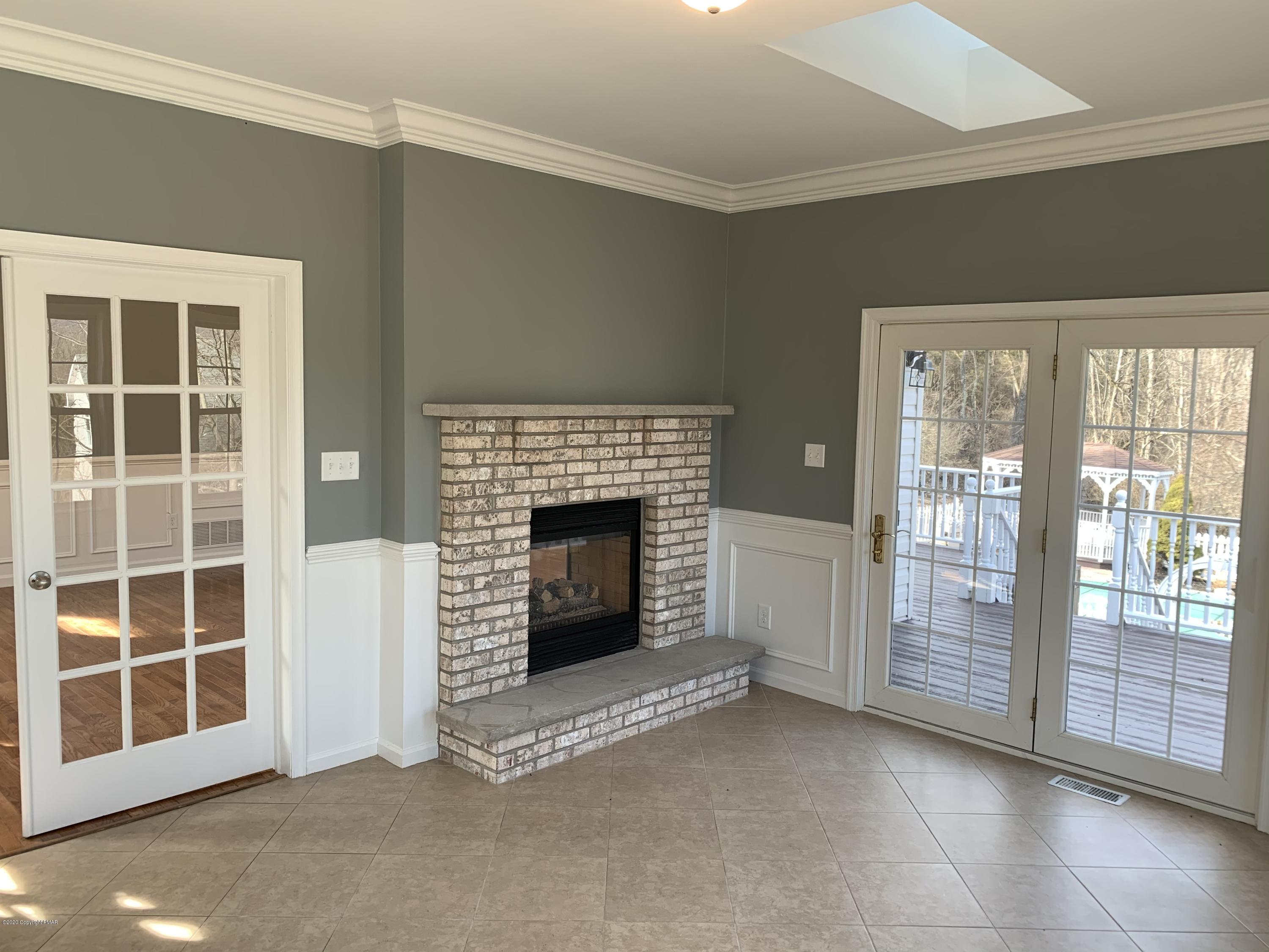 1697 Middle Road Stroudsburg, PA 18360 - Photo 66 of 116 a view of an empty room with a fireplace and a window
