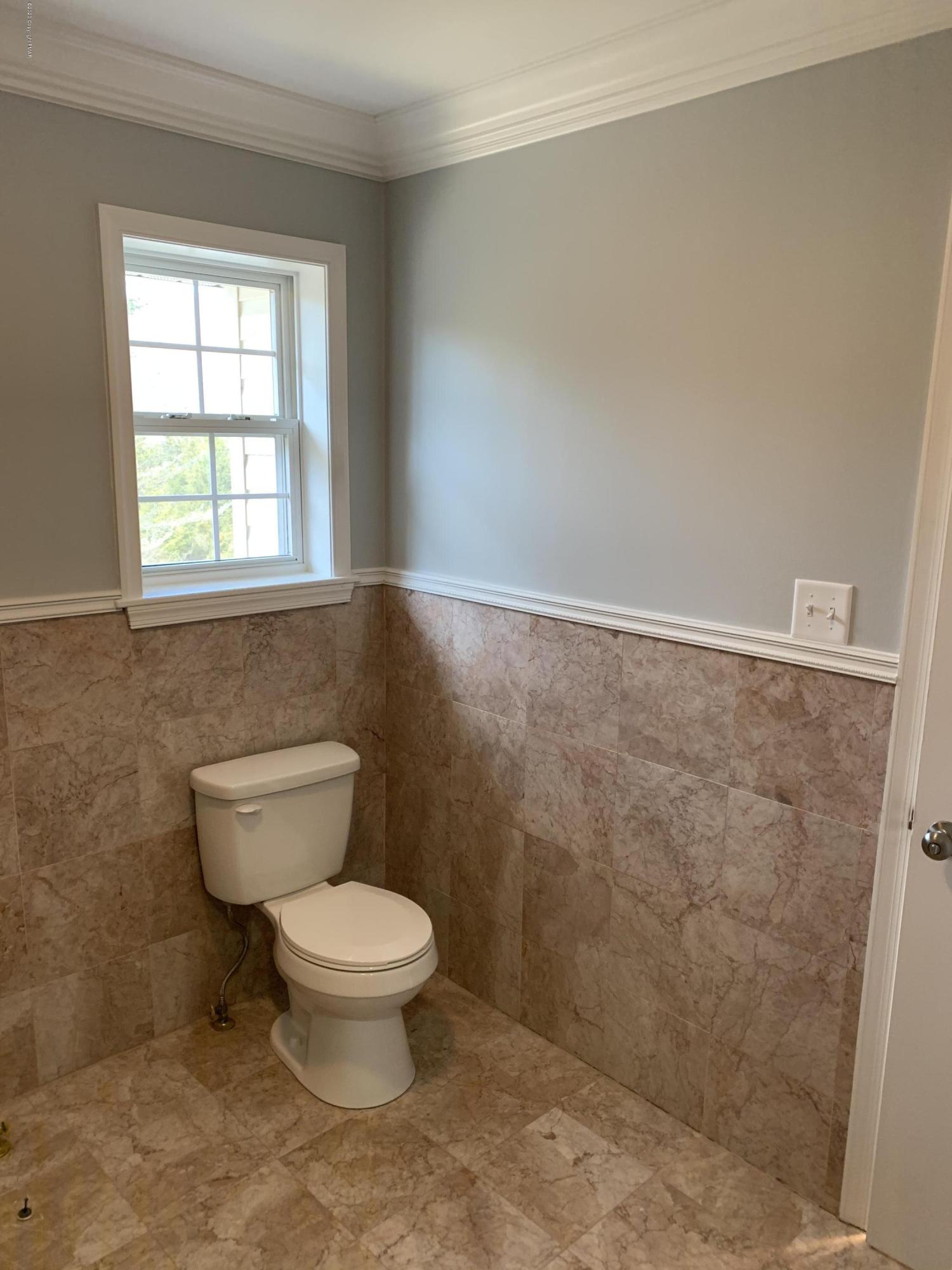 1697 Middle Road Stroudsburg, PA 18360 - Photo 87 of 116 a bathroom with a toilet a window and a shower