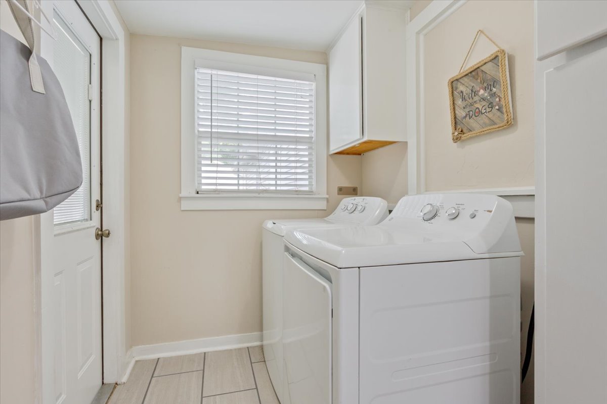 1607 North Harding Avenue Cameron, TX 76520 - Photo 30 of 37 A well-appointed utility room features a washer, dryer, and cabinet storage, ensuring daily chores are a breeze.