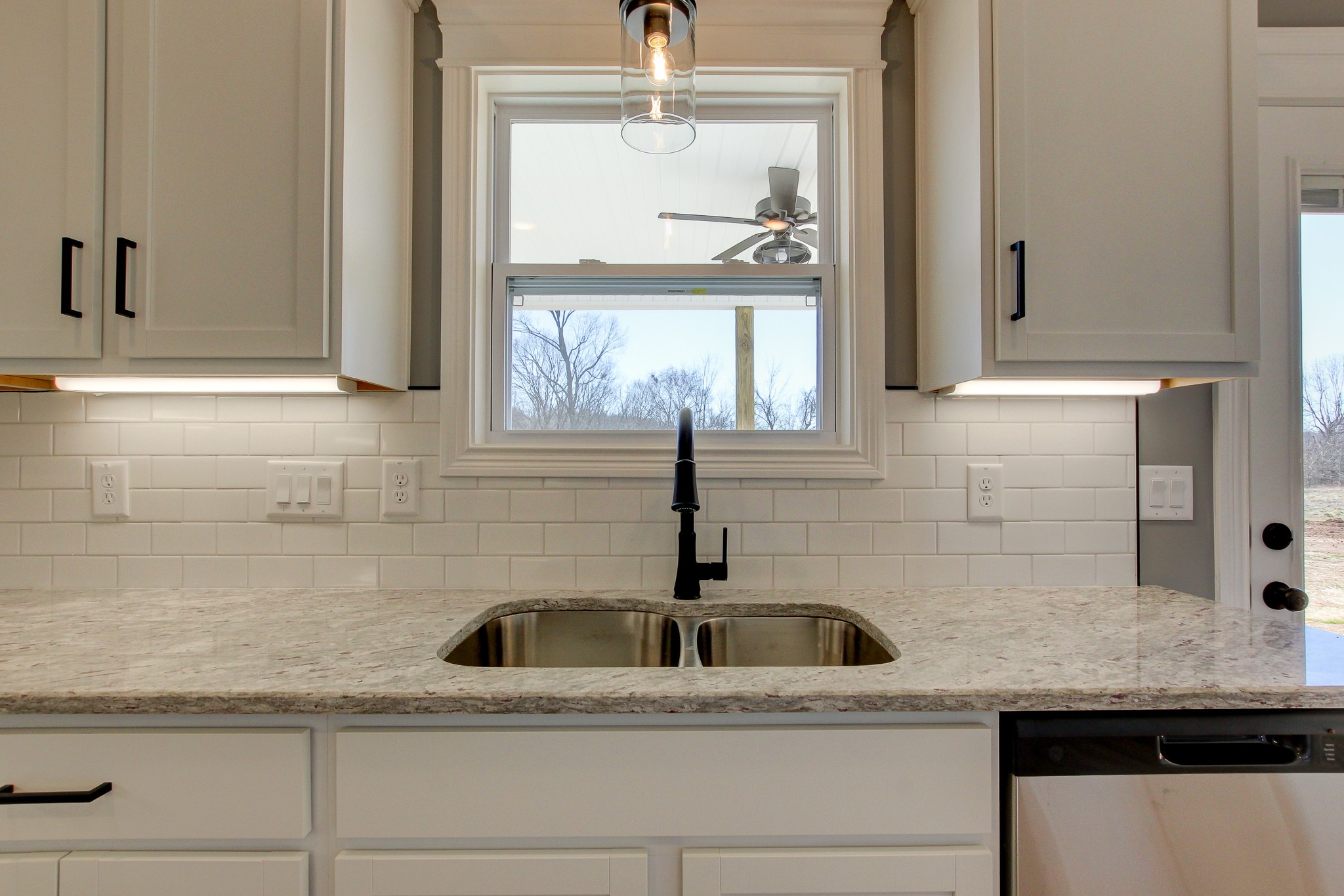 842 Burley Barn Road Clarksville, TN 37042 - Photo 11 of 49 a kitchen with granite countertop a sink and white cabinets