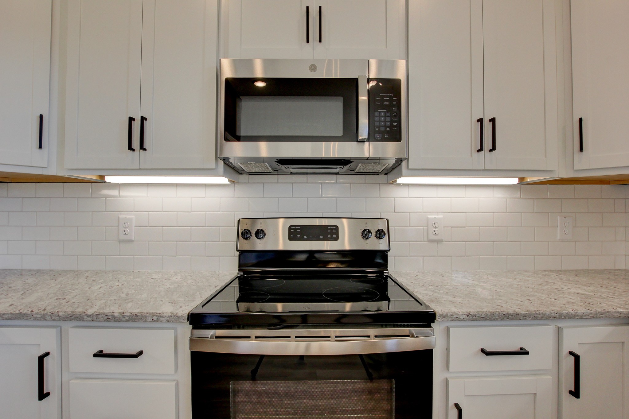 842 Burley Barn Road Clarksville, TN 37042 - Photo 12 of 49 a kitchen with granite countertop a stove and a microwave