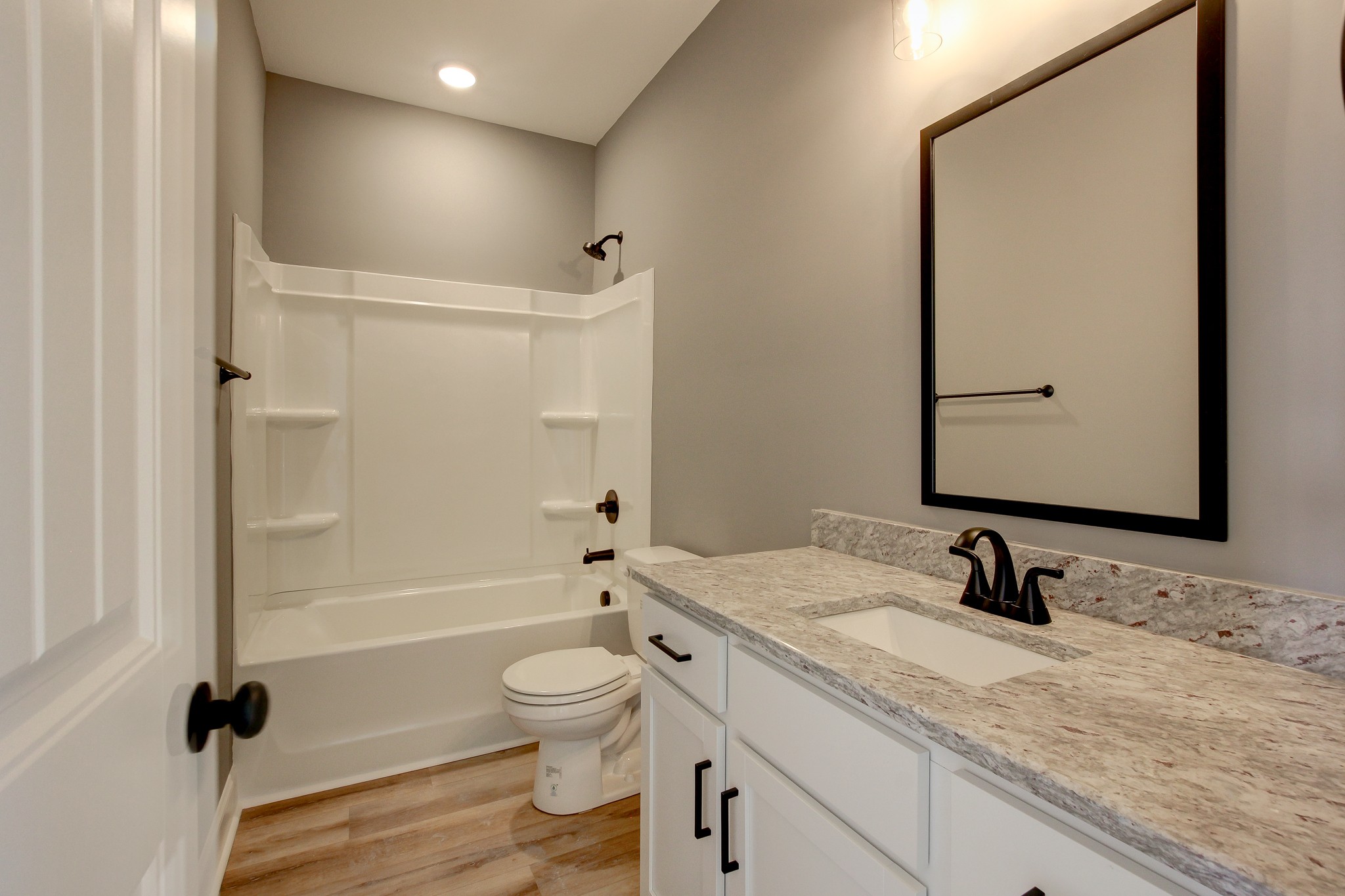 842 Burley Barn Road Clarksville, TN 37042 - Photo 21 of 49 a bathroom with a granite countertop sink toilet a mirror and shower