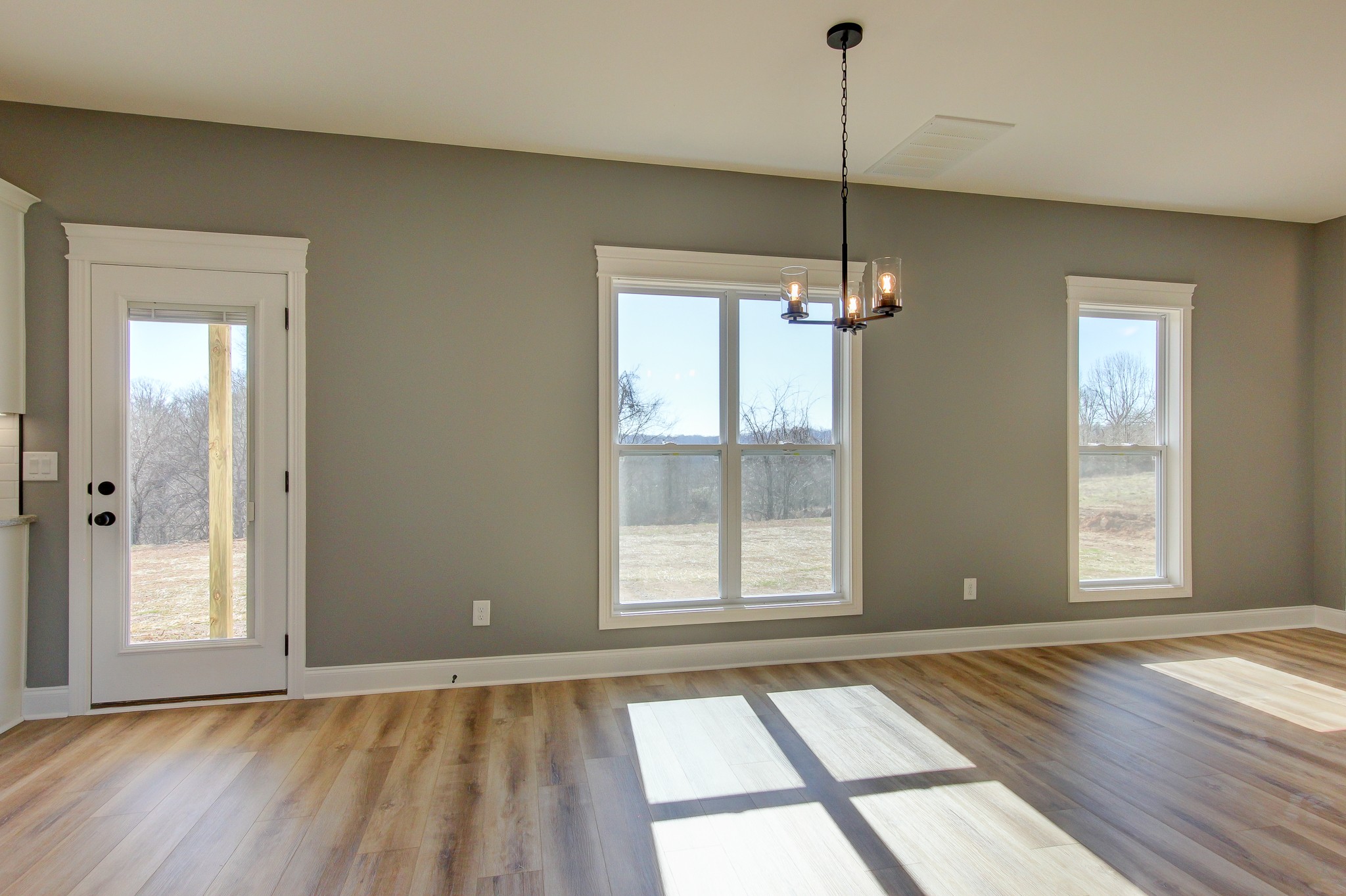 842 Burley Barn Road Clarksville, TN 37042 - Photo 4 of 49 a view of an empty room with a window and wooden floor