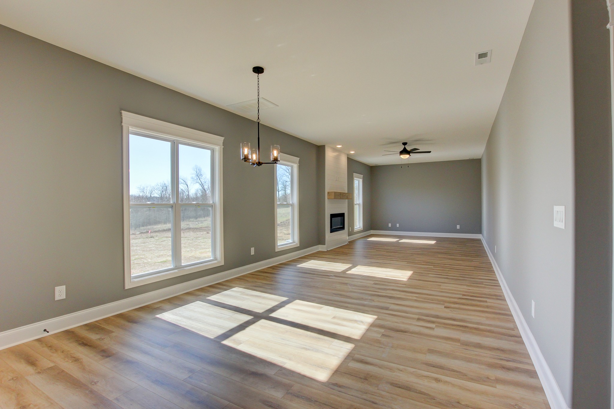 842 Burley Barn Road Clarksville, TN 37042 - Photo 6 of 49 a view of an empty room with wooden floor and a window