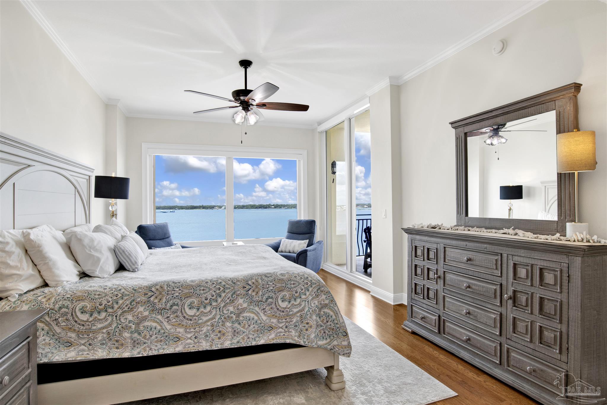 14500 River Road, Unit 507 Pensacola, FL 32507 - Photo 14 of 56 a bedroom with a large bed and a chandelier