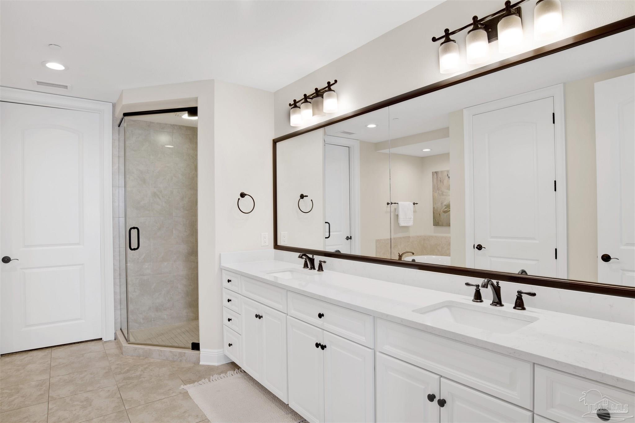 14500 River Road, Unit 507 Pensacola, FL 32507 - Photo 16 of 56 a bathroom with a double vanity sink mirror and shower
