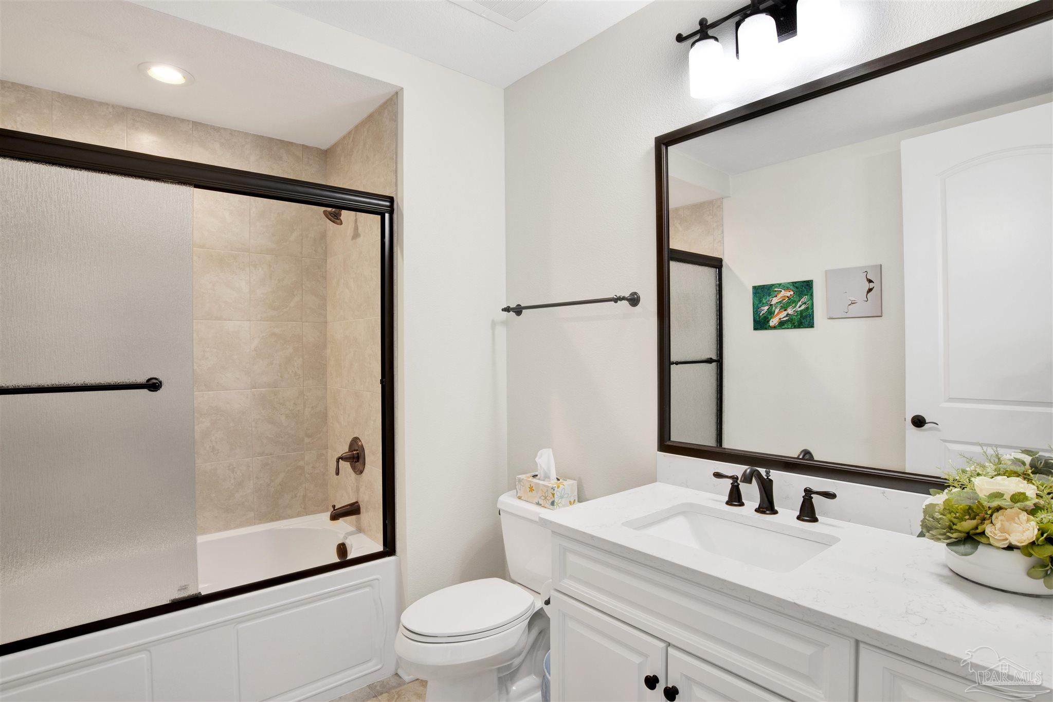 14500 River Road, Unit 507 Pensacola, FL 32507 - Photo 24 of 56 a bathroom with a bathtub shower sink vanity and toilet