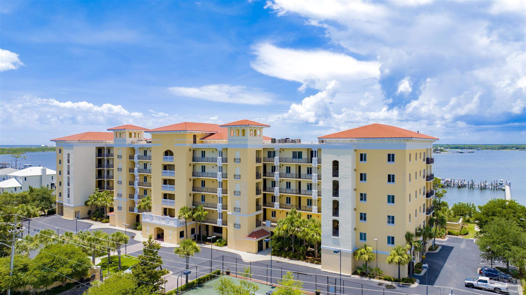 14500 River Road, Unit 507 Pensacola, FL 32507 - Photo 3 of 56 a view of a multi story residential apartment building with a yard