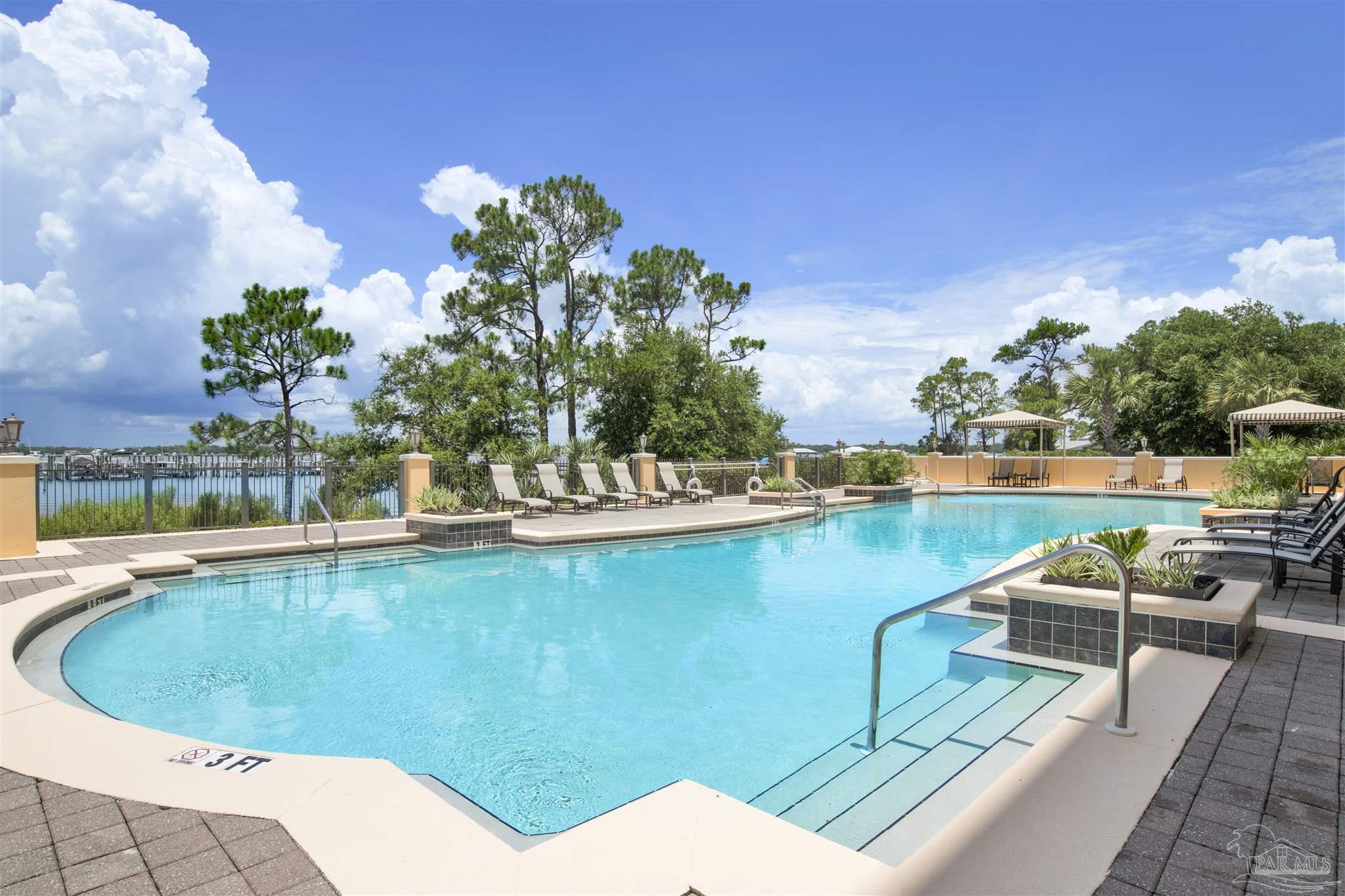 14500 River Road, Unit 507 Pensacola, FL 32507 - Photo 32 of 56 a view of a swimming pool with a lounge chairs