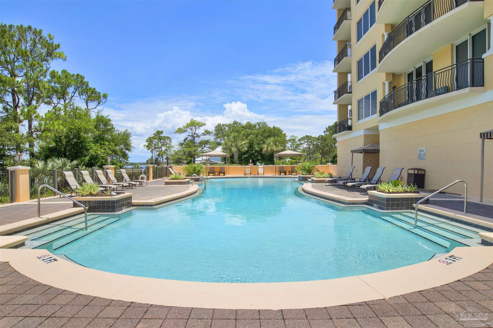 14500 River Road, Unit 507 Pensacola, FL 32507 - Photo 33 of 56 a view of a swimming pool with chairs