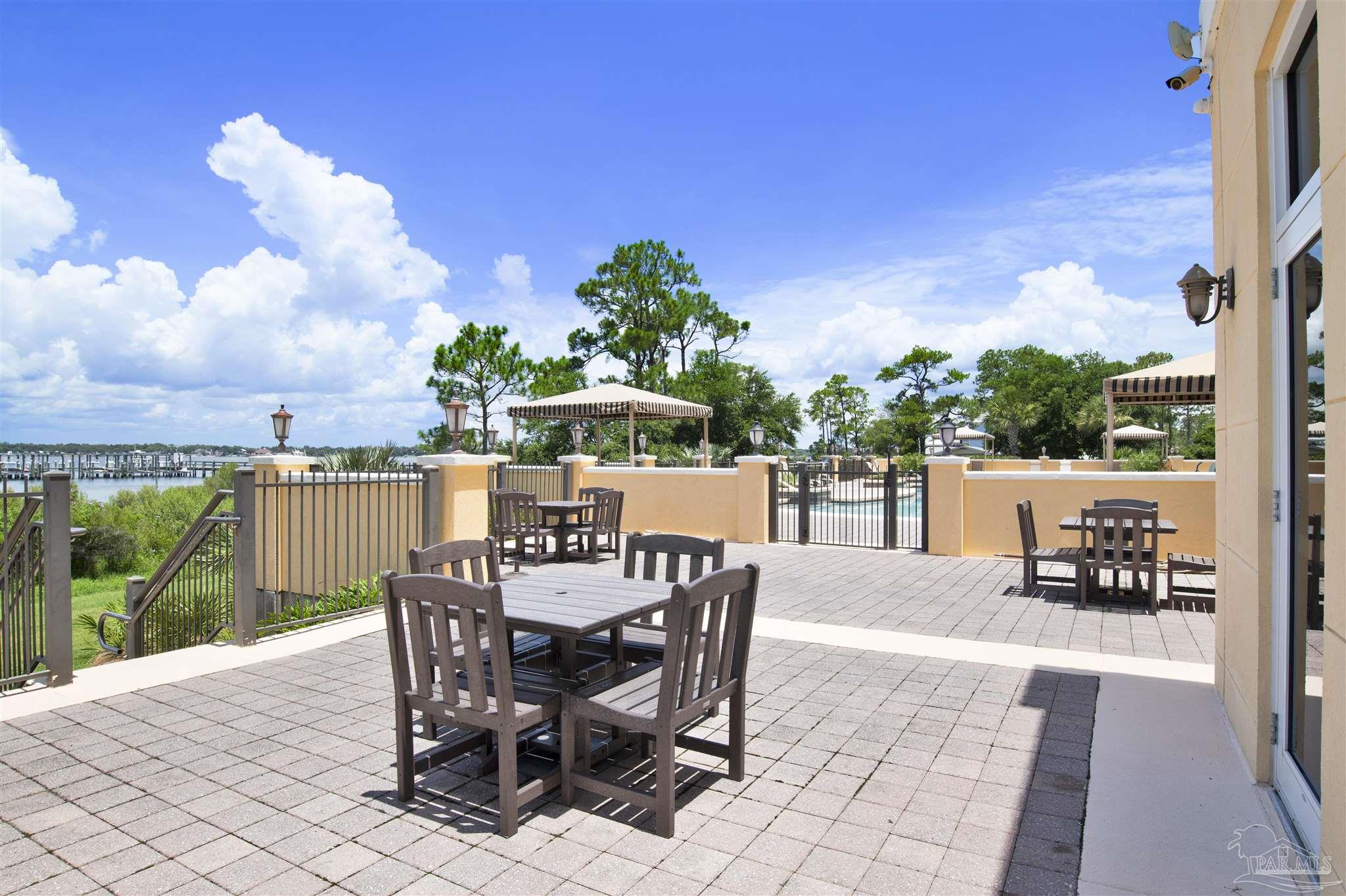14500 River Road, Unit 507 Pensacola, FL 32507 - Photo 36 of 56 a view of a patio with a table chairs and a table