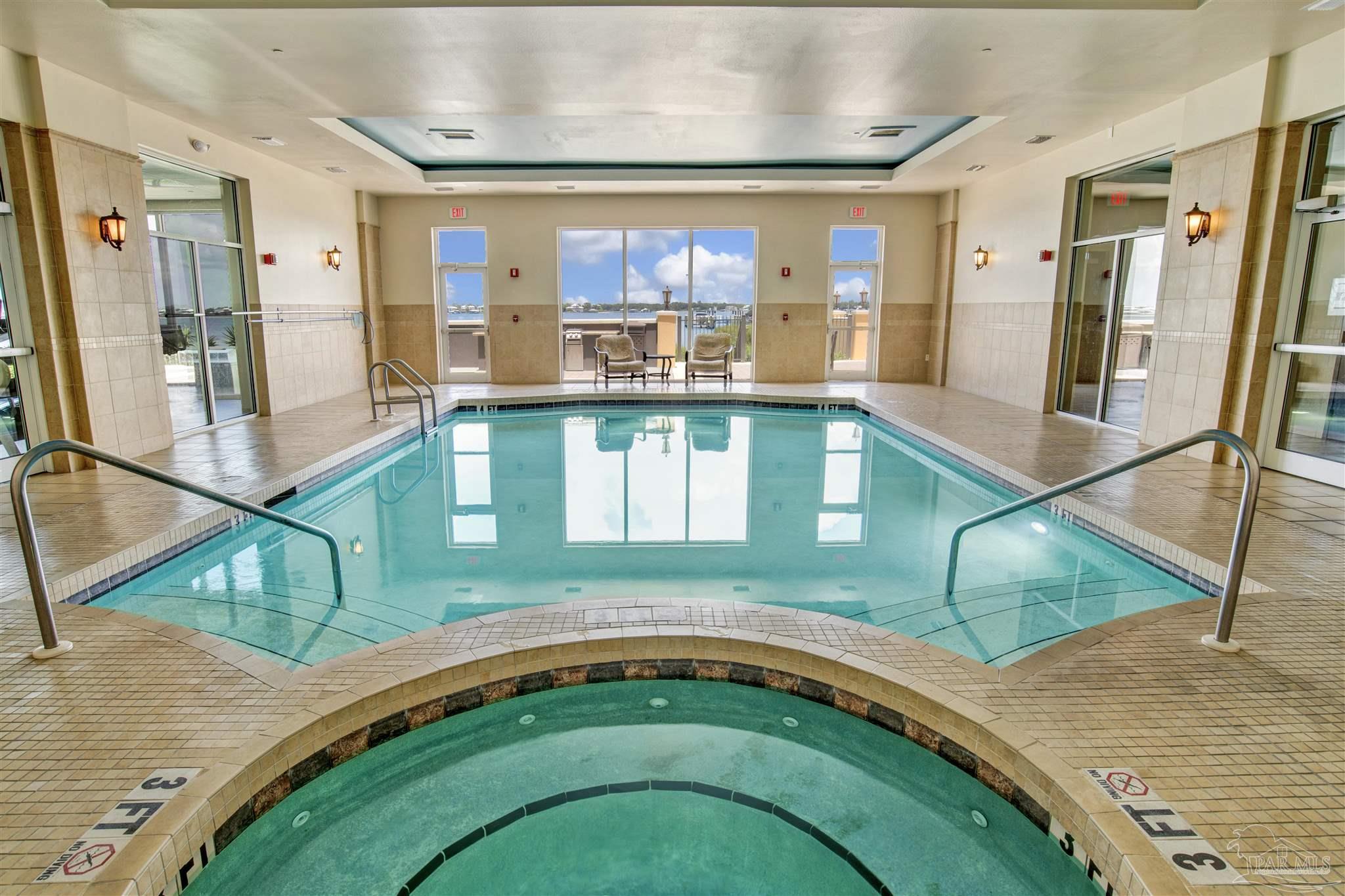 14500 River Road, Unit 507 Pensacola, FL 32507 - Photo 39 of 56 a living room with a gaming machine and a dining table