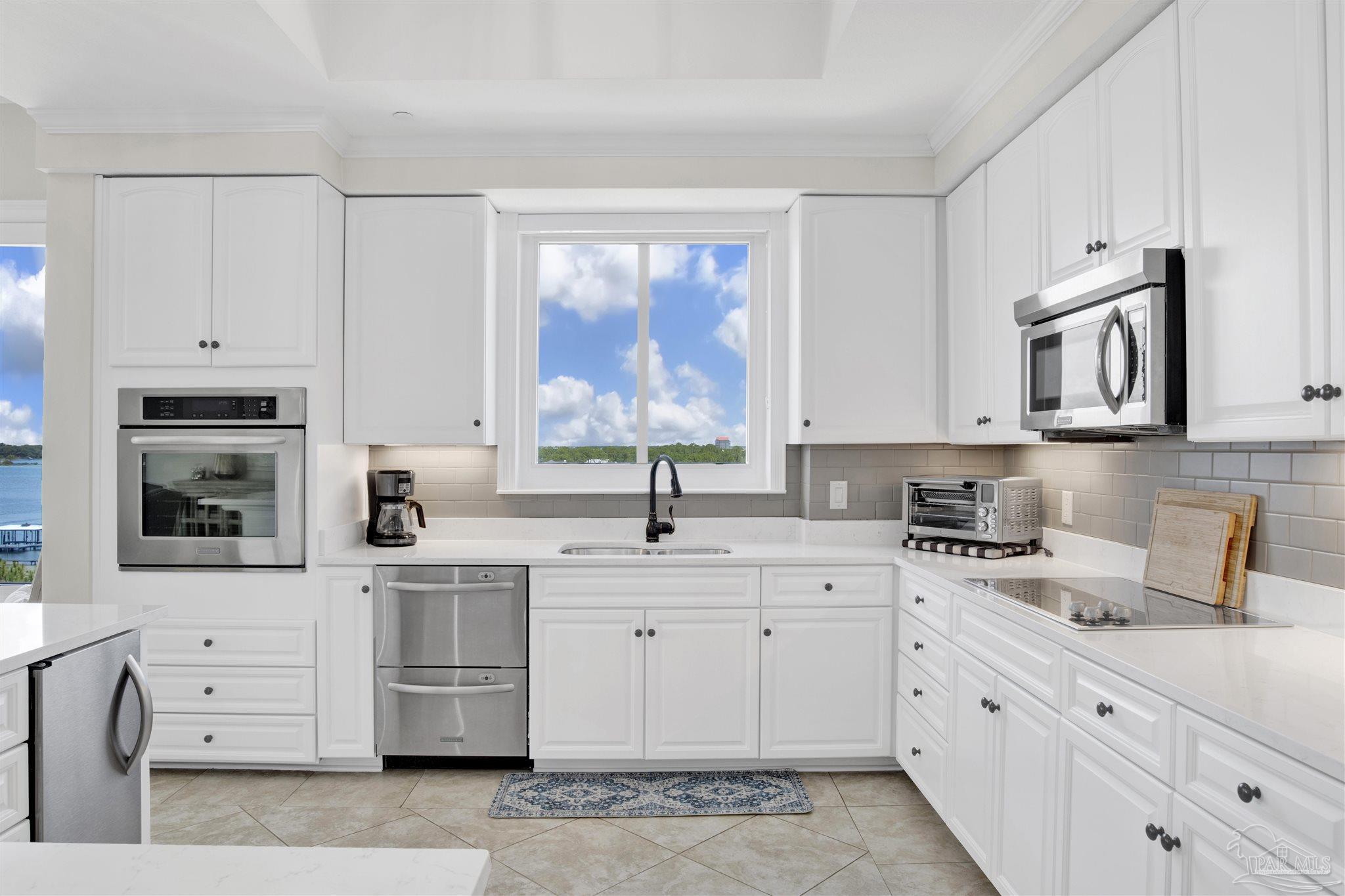 14500 River Road, Unit 507 Pensacola, FL 32507 - Photo 4 of 56 a kitchen with cabinets appliances a sink and a window