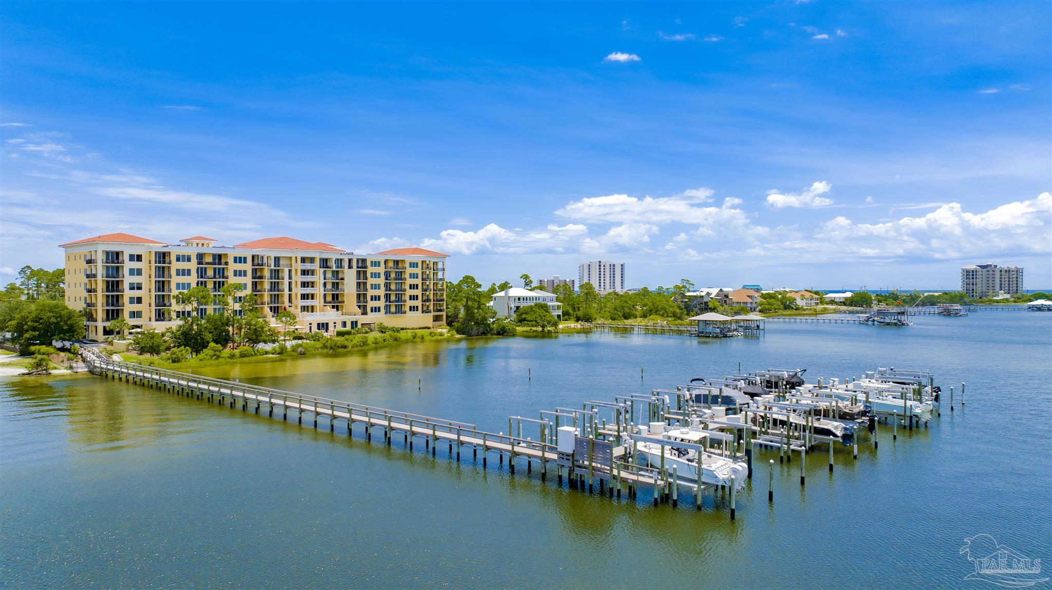 14500 River Road, Unit 507 Pensacola, FL 32507 - Photo 52 of 56 a view of an ocean with boats and trees in the background