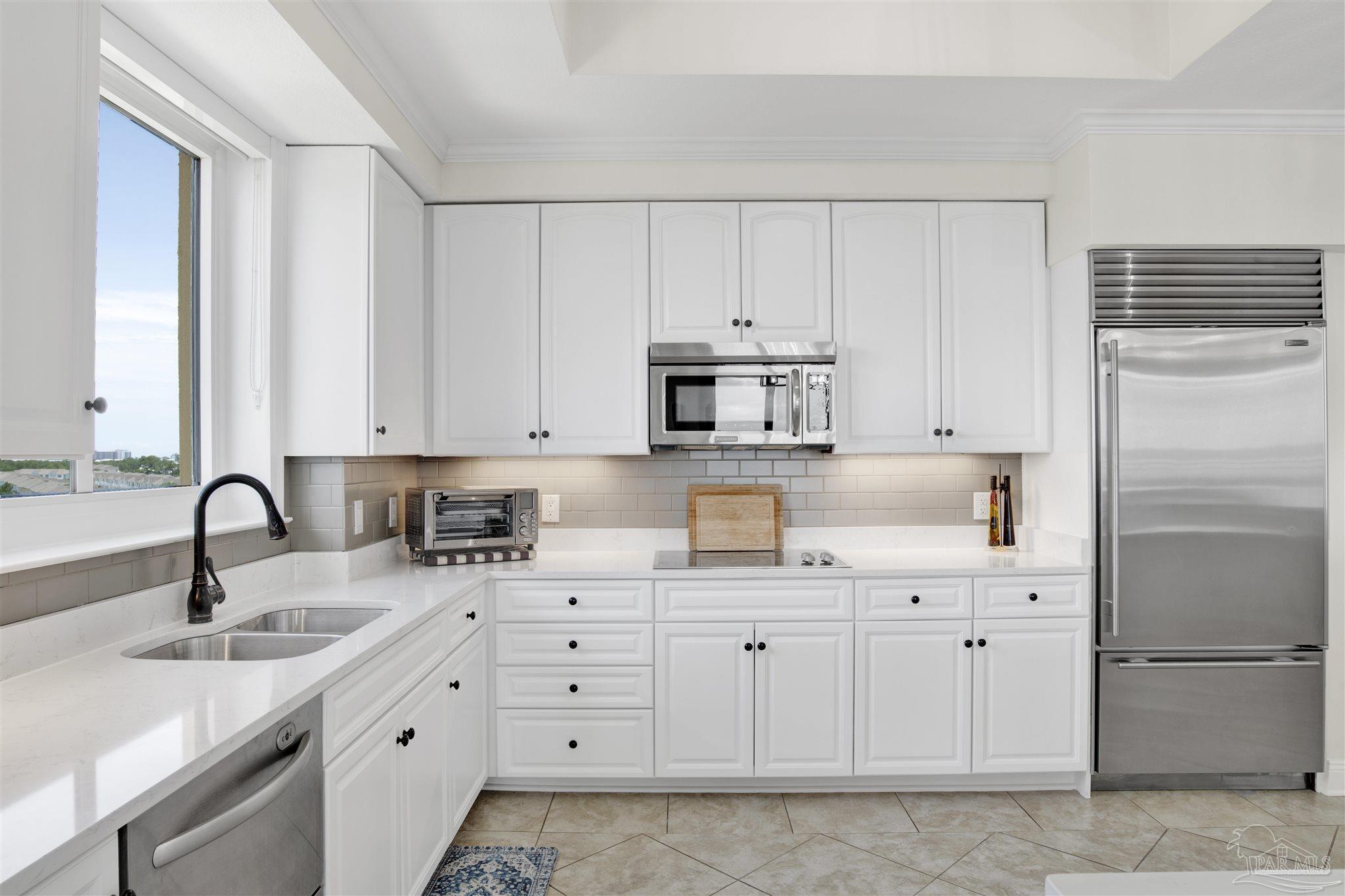 14500 River Road, Unit 507 Pensacola, FL 32507 - Photo 6 of 56 a kitchen with white cabinets and sink