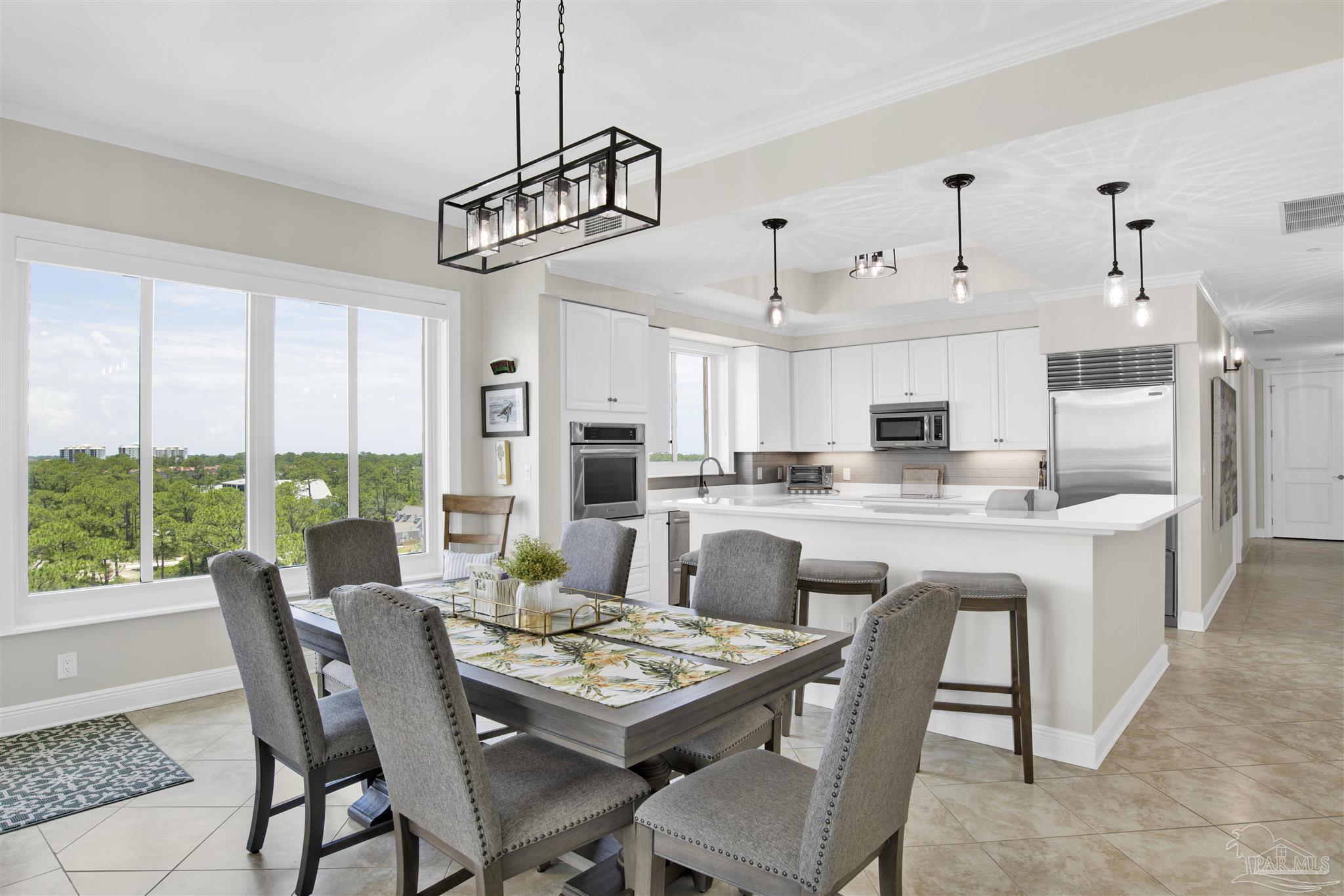 14500 River Road, Unit 507 Pensacola, FL 32507 - Photo 9 of 56 a dining room with stainless steel appliances kitchen island granite countertop a table and chairs