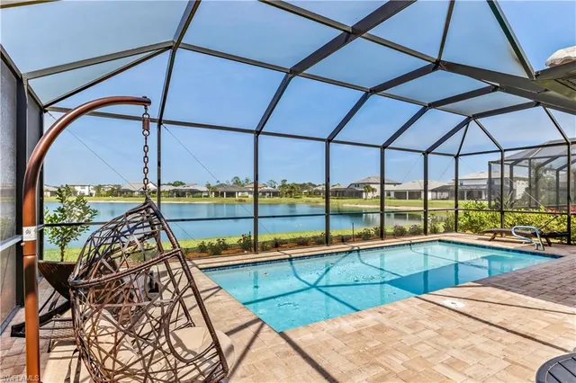 a view of a swimming pool with a lounge chair