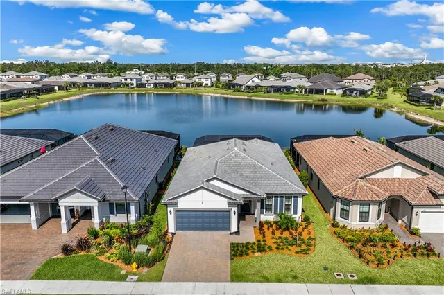 a view of a house with swimming pool and a yard