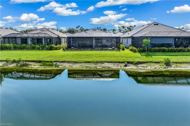 a view of a house with swimming pool and sitting area