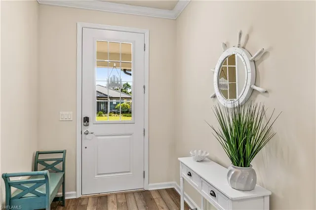 a living room with furniture a chandelier and a large window