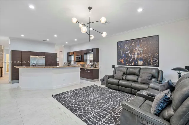a living room with furniture and kitchen view