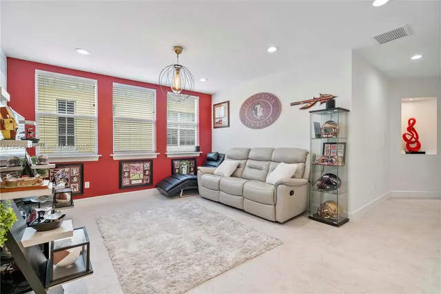 a living room with furniture a window and a clock