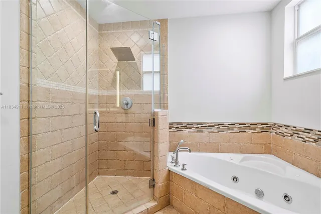 a bathroom with a bathtub and shower