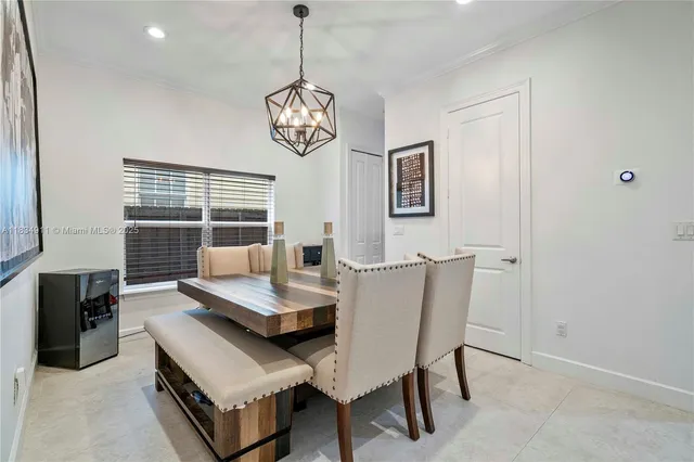 a view of a dining room with furniture wooden floor and a chandelier