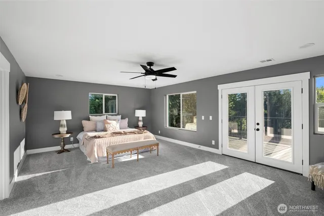 a bedroom with a large bed and a large window