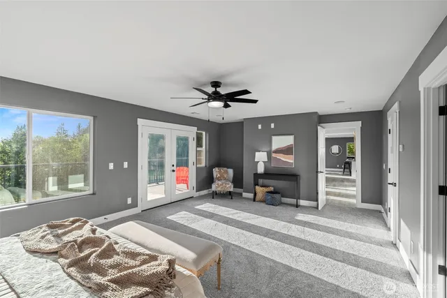 a bedroom with a bed and glass windows