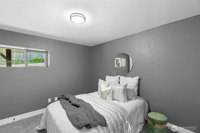 a bedroom with a bed and a window