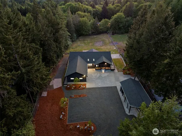 an aerial view of a house with yard swimming pool and outdoor seating