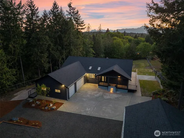 an aerial view of a house with yard swimming pool and outdoor seating
