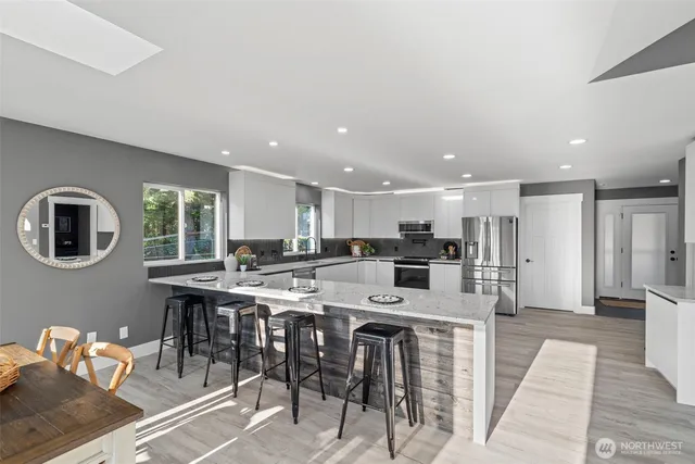 a large kitchen with a table and chairs